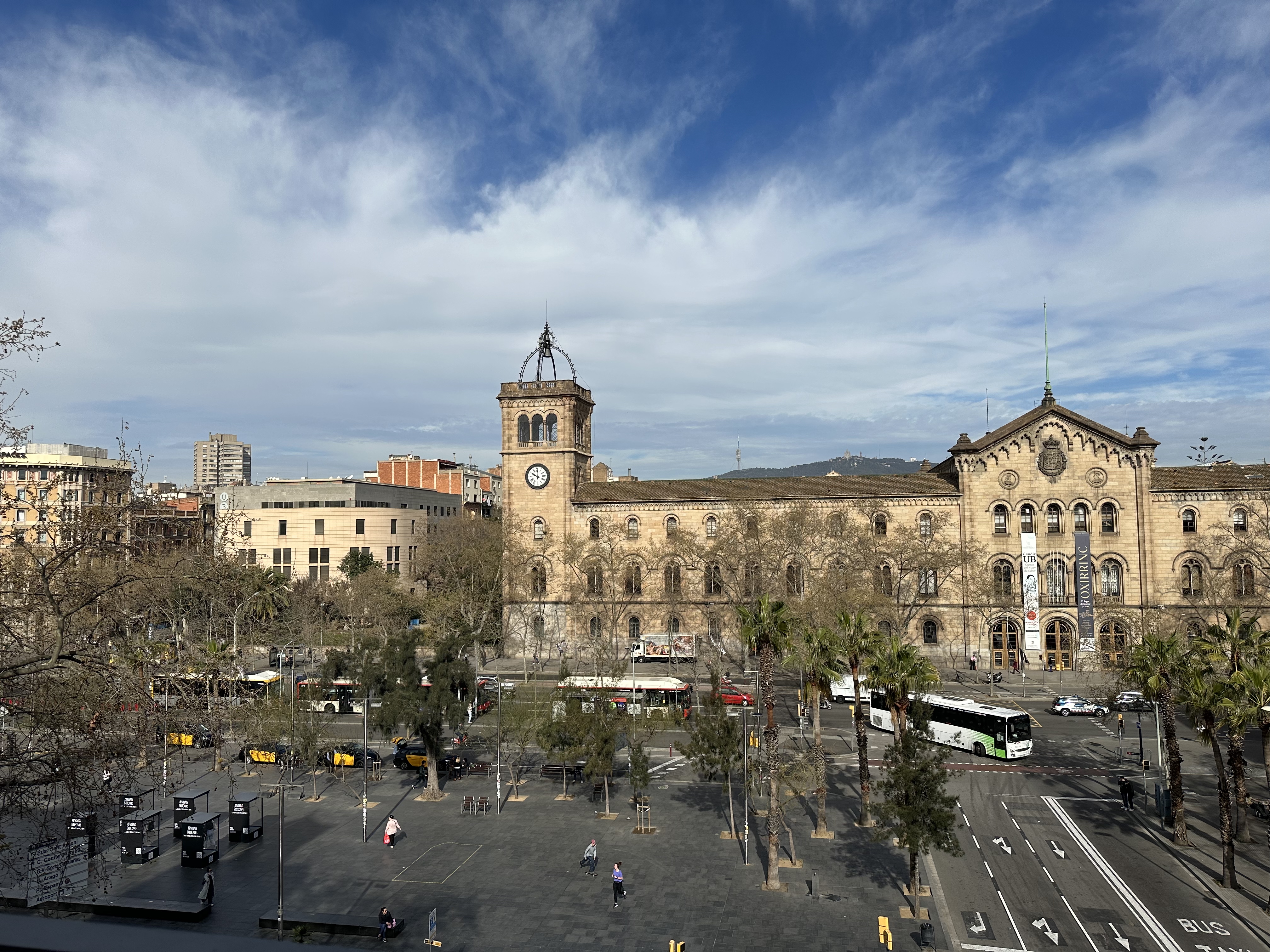 Hand holding yellow mug on brown leather desk mat with laptop